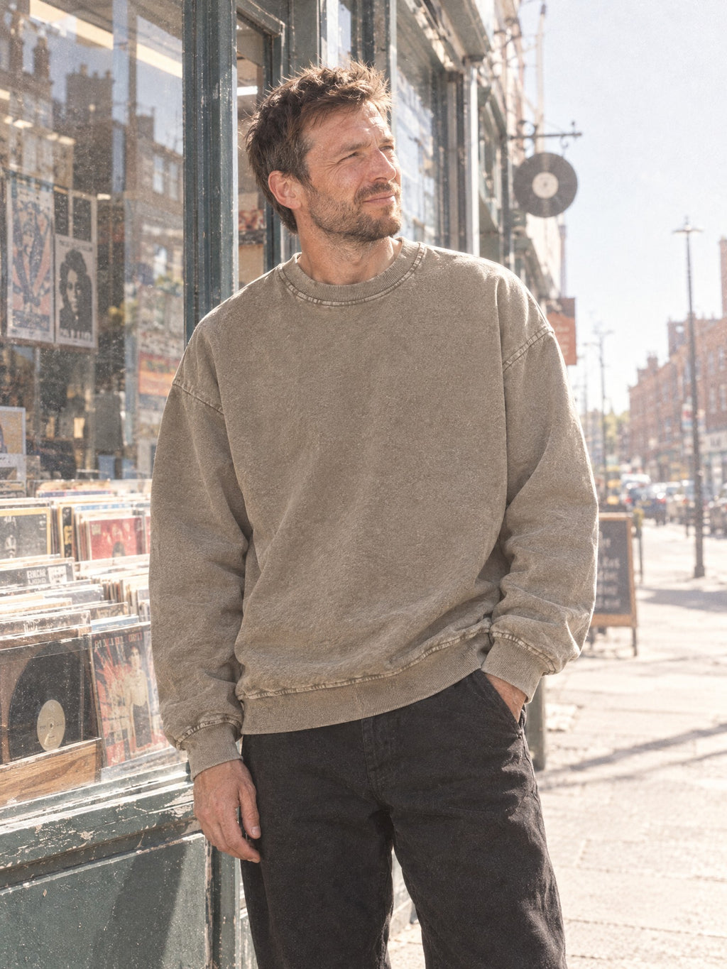 Man wearing the Men's Snow Wash Oversized Sweatshirt in Stone Gray with black trousers